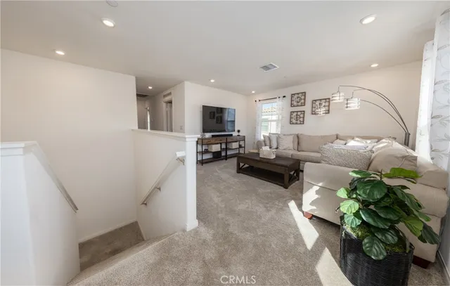 a living room with furniture and a potted plant