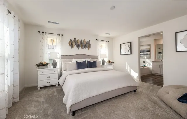 a spacious bedroom with a bed and a painting on the wall