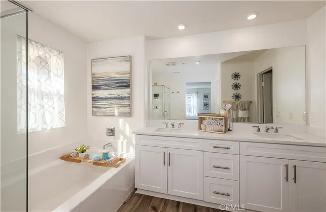 a bathroom with a sink double vanity and a bathtub
