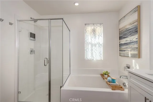 a bathroom with a tub shower and window