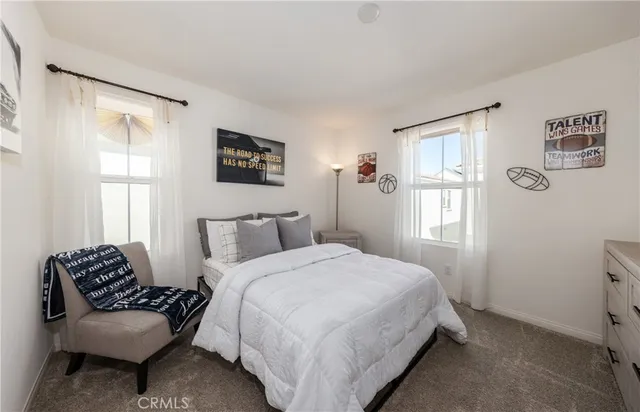 a bedroom with a bed and a couch