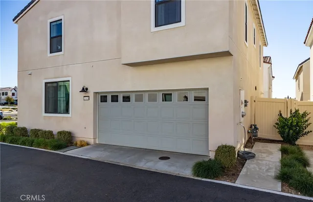 a front view of a house with plants
