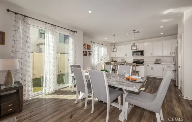 a view of a dining room with furniture and wooden floor