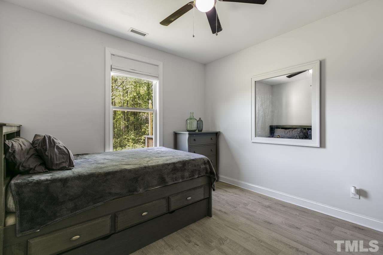8340 Yellow Aster Court Willow Spring, NC 27592 - Photo 14 of 35 a bedroom with a bed and window