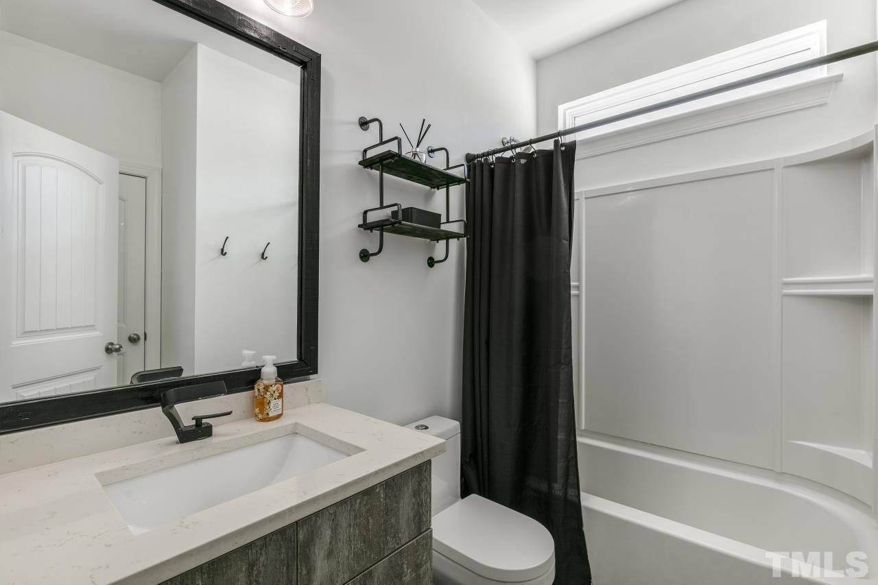 8340 Yellow Aster Court Willow Spring, NC 27592 - Photo 15 of 35 a bathroom with a sink toilet and shower