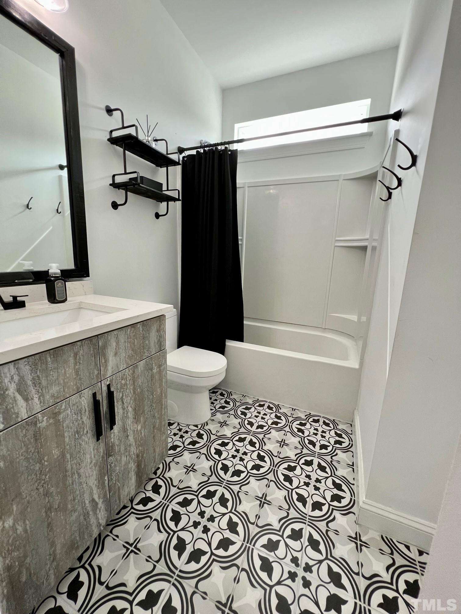 8340 Yellow Aster Court Willow Spring, NC 27592 - Photo 16 of 35 a bathroom with a sink toilet and shower