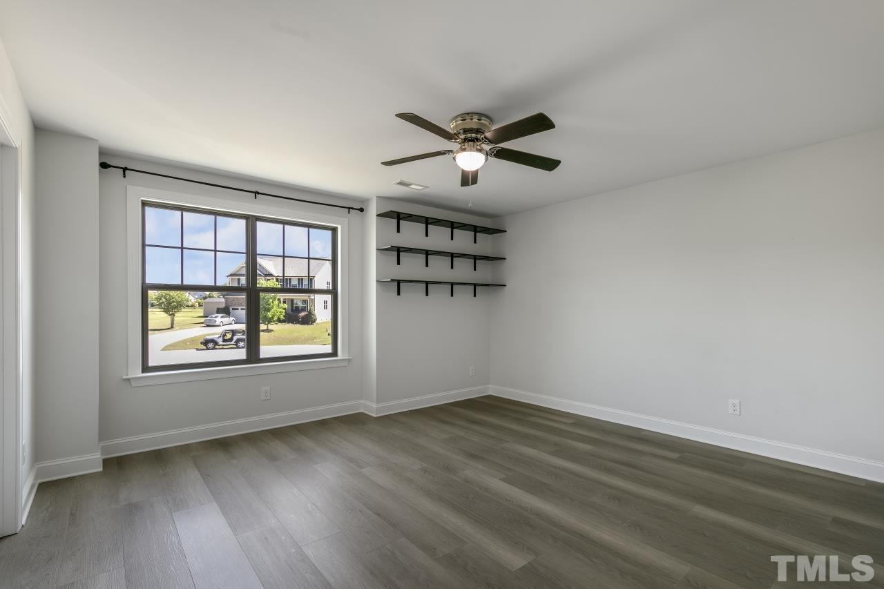 8340 Yellow Aster Court Willow Spring, NC 27592 - Photo 25 of 35 a view of empty room with wooden floor and fan