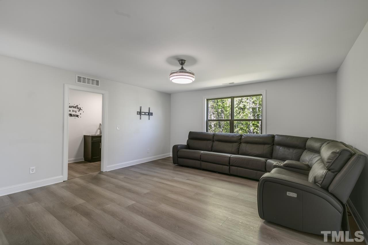 8340 Yellow Aster Court Willow Spring, NC 27592 - Photo 26 of 35 a living room with furniture and window
