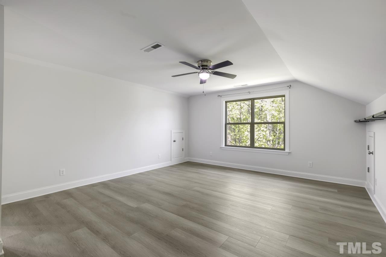 8340 Yellow Aster Court Willow Spring, NC 27592 - Photo 28 of 35 an empty room with wooden floor and windows