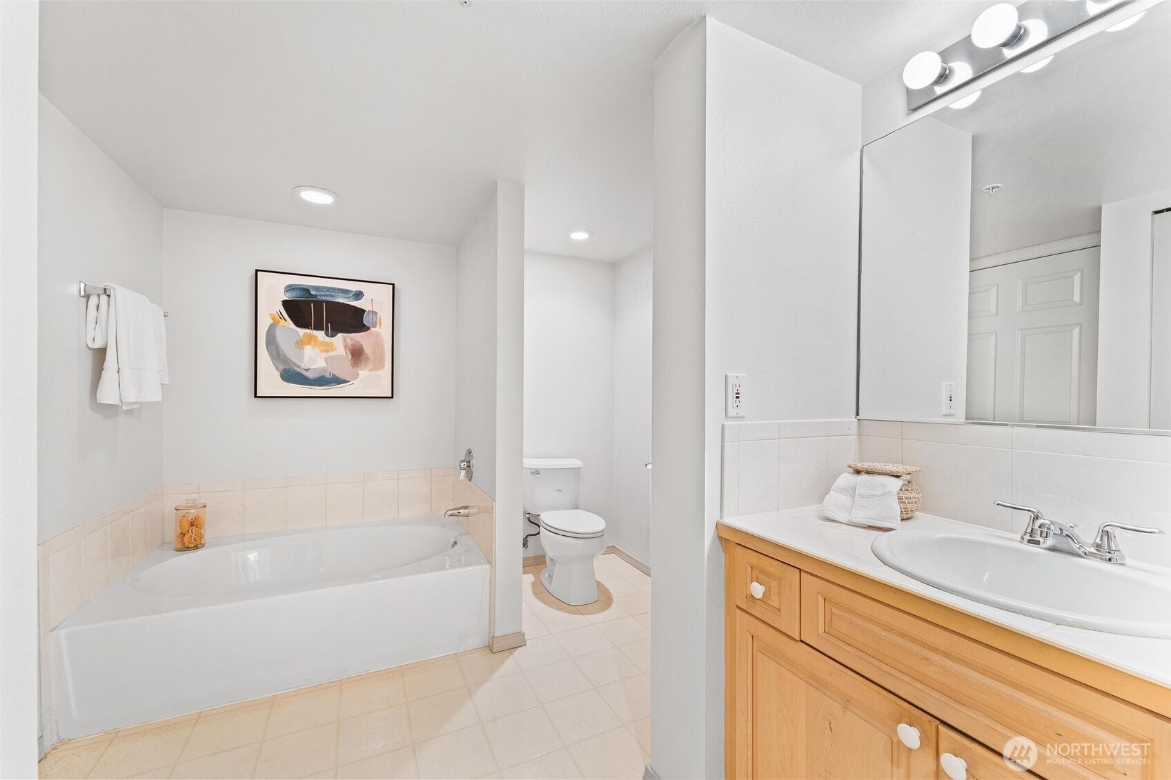 15020 Bothell Way Northeast, Unit 502 Lake Forest Park, WA 98155 - Photo 16 of 30 a bathroom with a granite countertop sink a toilet and bathtub