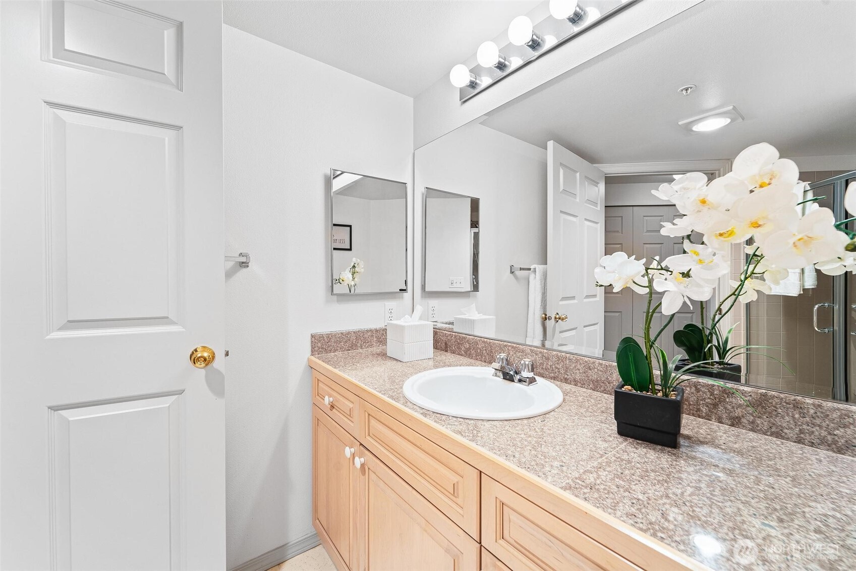 15020 Bothell Way Northeast, Unit 502 Lake Forest Park, WA 98155 - Photo 19 of 30 a bathroom with a sink a mirror and a shower