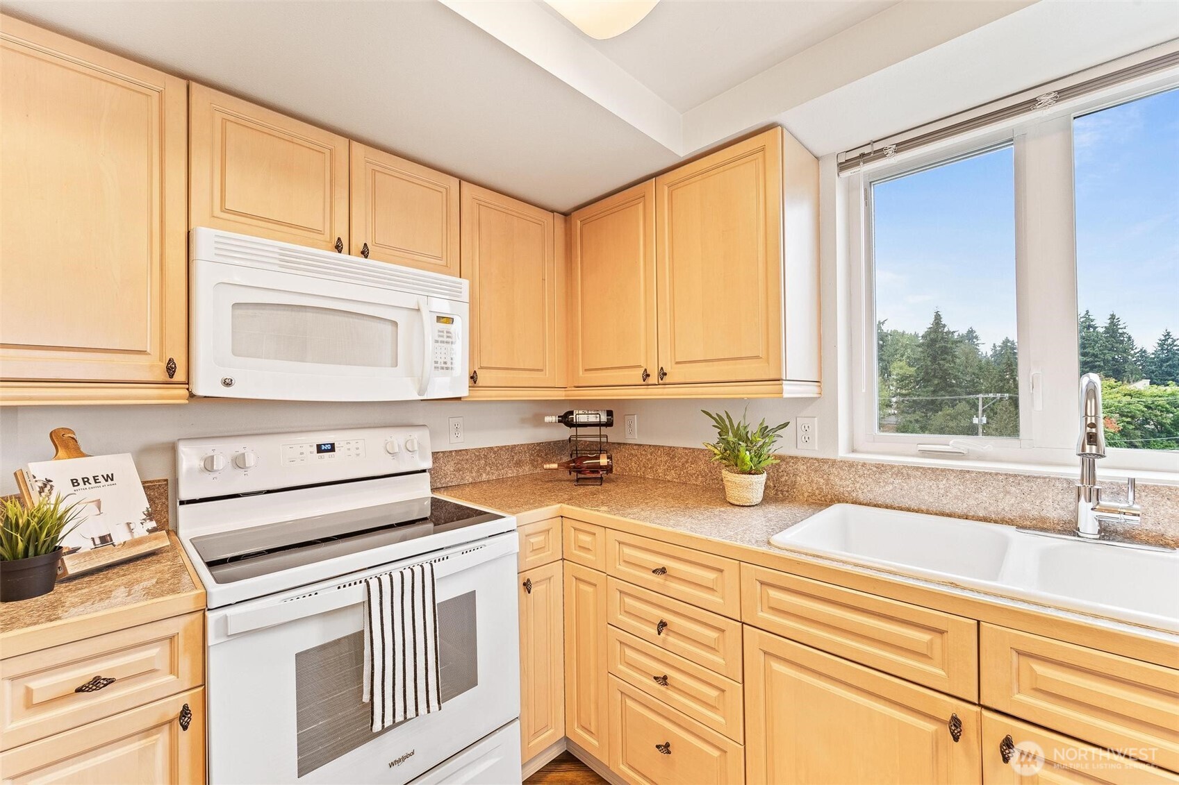 15020 Bothell Way Northeast, Unit 502 Lake Forest Park, WA 98155 - Photo 8 of 30 a kitchen with stainless steel appliances white cabinets and a window