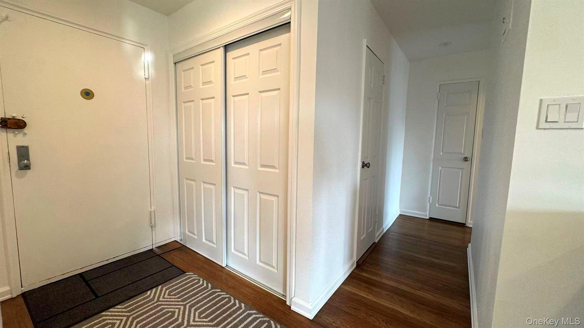211-10 18th Avenue, Unit 6C Queens, NY 11360 - Photo 11 of 16 a view of a hallway with wooden floor