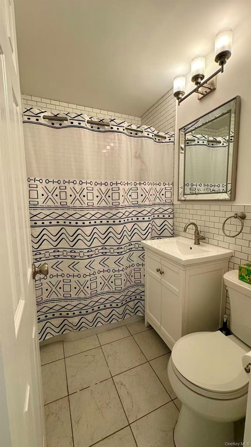 211-10 18th Avenue, Unit 6C Queens, NY 11360 - Photo 13 of 16 a bathroom with a sink toilet and shower