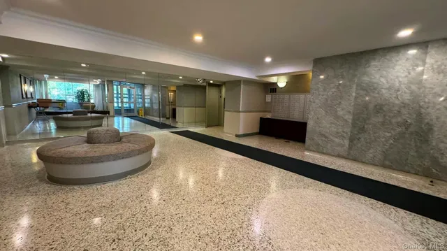 a lobby with furniture and a potted plant