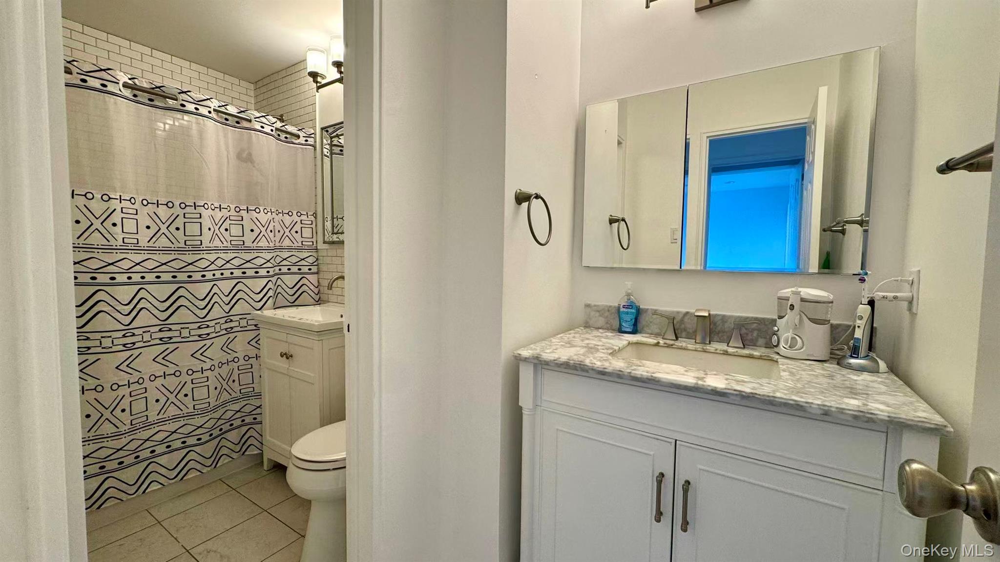 211-10 18th Avenue, Unit 6C Queens, NY 11360 - Photo 8 of 16 a bathroom with a granite countertop sink toilet and shower