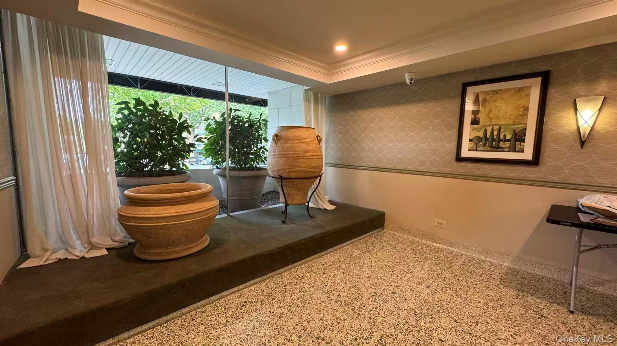 211-10 18th Avenue, Unit 6C Queens, NY 11360 - Photo 9 of 16 a living room with a couch and a table