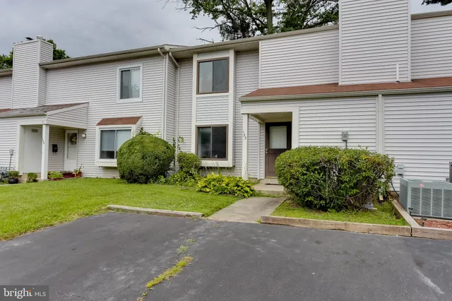 a house with a small garden area and potted plants