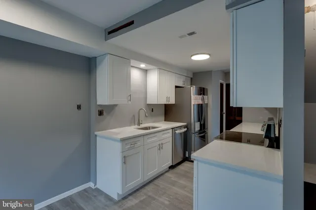 a kitchen with a sink a stove and refrigerator