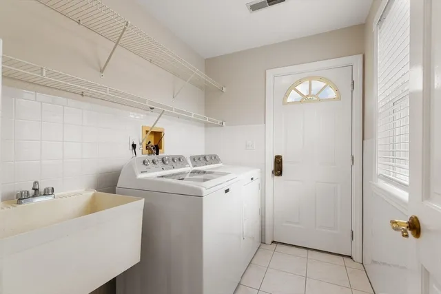 a utility room with closet dryer and washer
