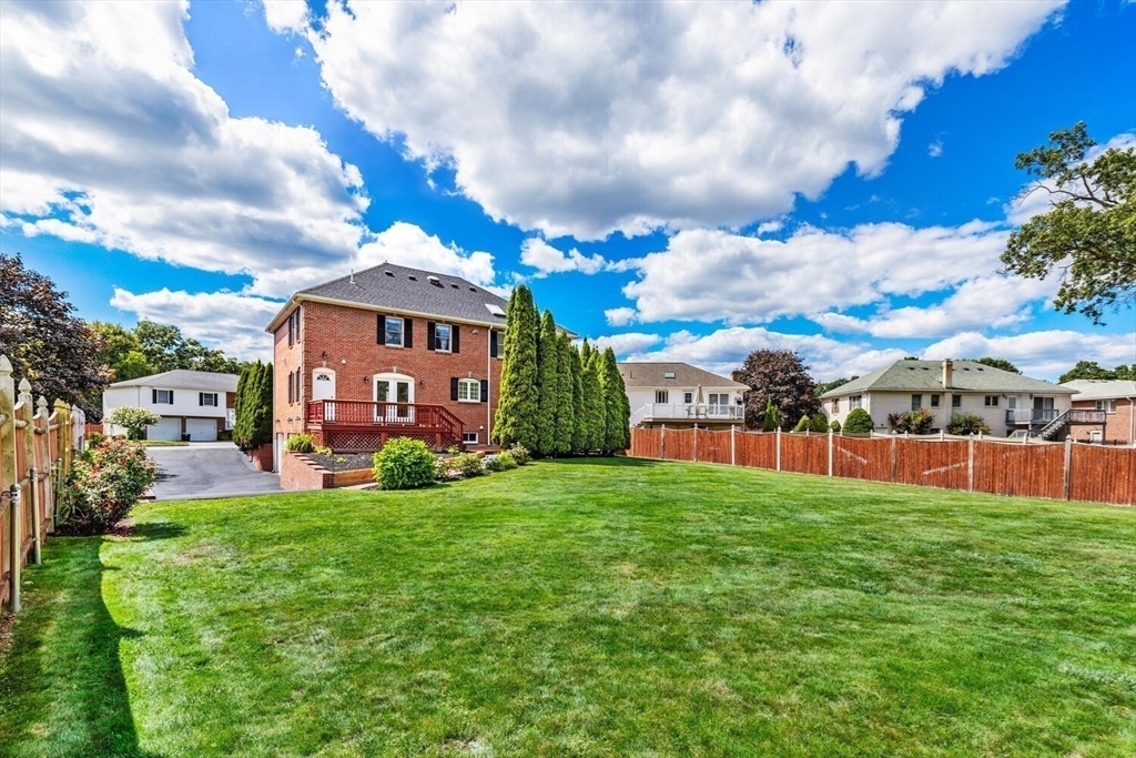 4 Gavin Circle Stoneham, MA 02180 - Photo 17 of 22 a view of a big yard next to a building
