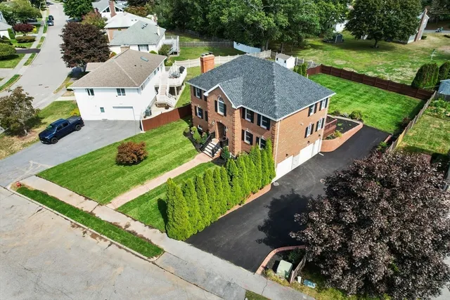 an aerial view of a house with a garden and trees