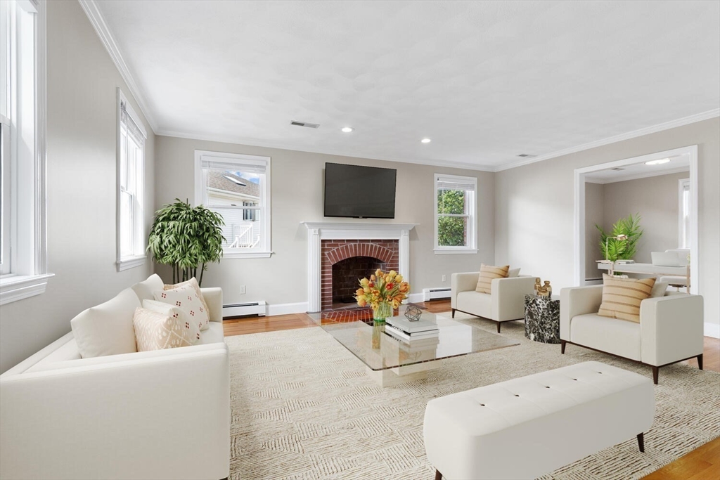 4 Gavin Circle Stoneham, MA 02180 - Photo 6 of 22 a living room with furniture and a fireplace