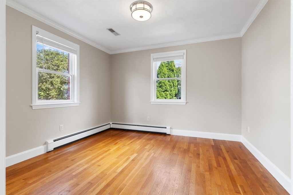 4 Gavin Circle Stoneham, MA 02180 - Photo 8 of 22 an empty room with wooden floor and windows