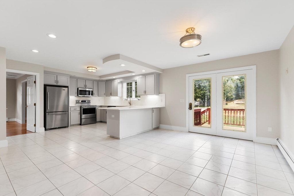 4 Gavin Circle Stoneham, MA 02180 - Photo 10 of 22 a large white kitchen with a stove a sink dishwasher and a refrigerator