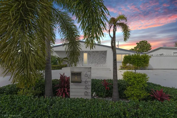 a view of house with palm trees