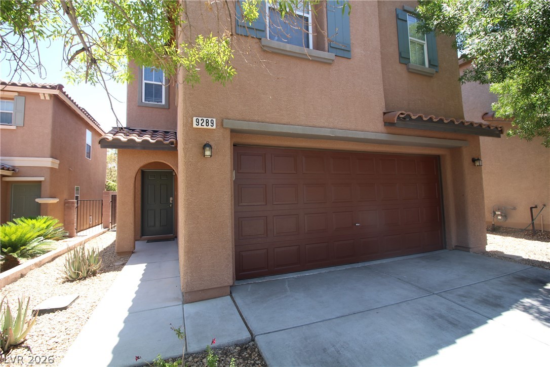 9289 Valley Ranch Avenue Las Vegas, NV 89178 - Photo 3 of 29 A well-maintained stucco facade with a two-car garage welcomes you to this desert oasis.