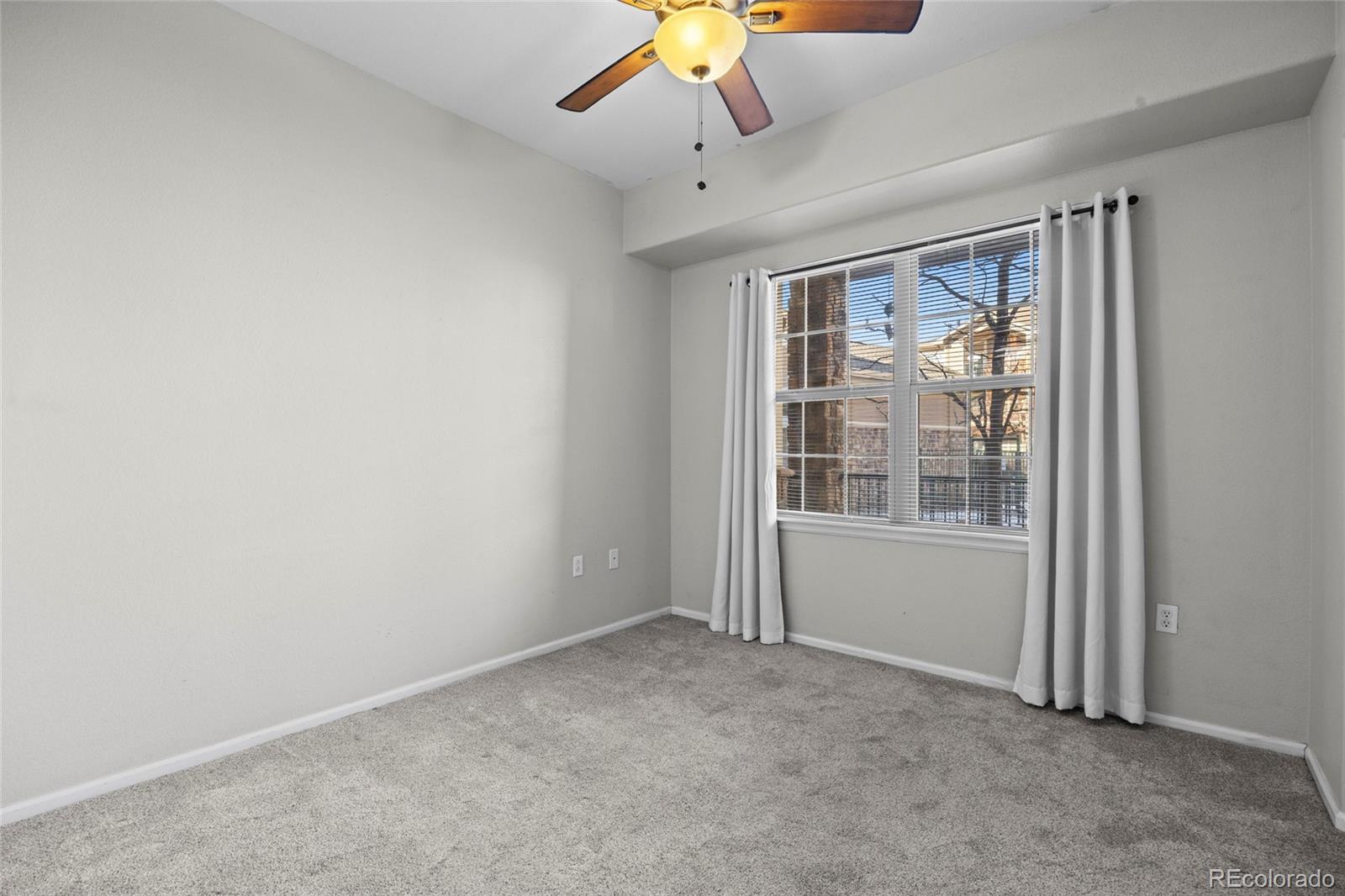 10805 Twenty Mile Road, Unit 104 Parker, CO 80134 - Photo 19 of 43 an empty room with a window
