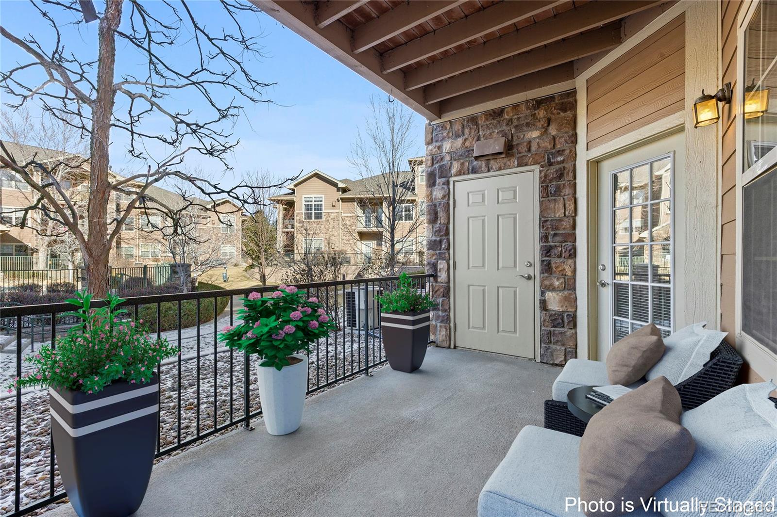10805 Twenty Mile Road, Unit 104 Parker, CO 80134 - Photo 23 of 43 a view of a patio with couches and a potted plant