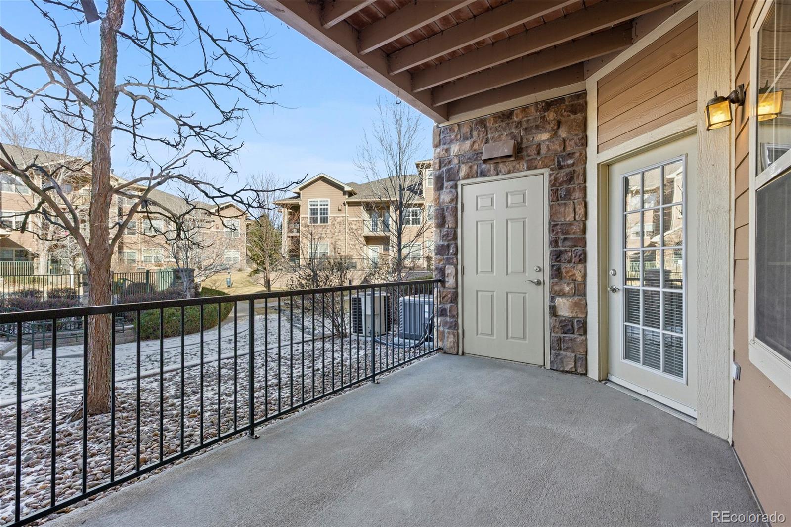 10805 Twenty Mile Road, Unit 104 Parker, CO 80134 - Photo 24 of 43 a view of a balcony with wooden fence