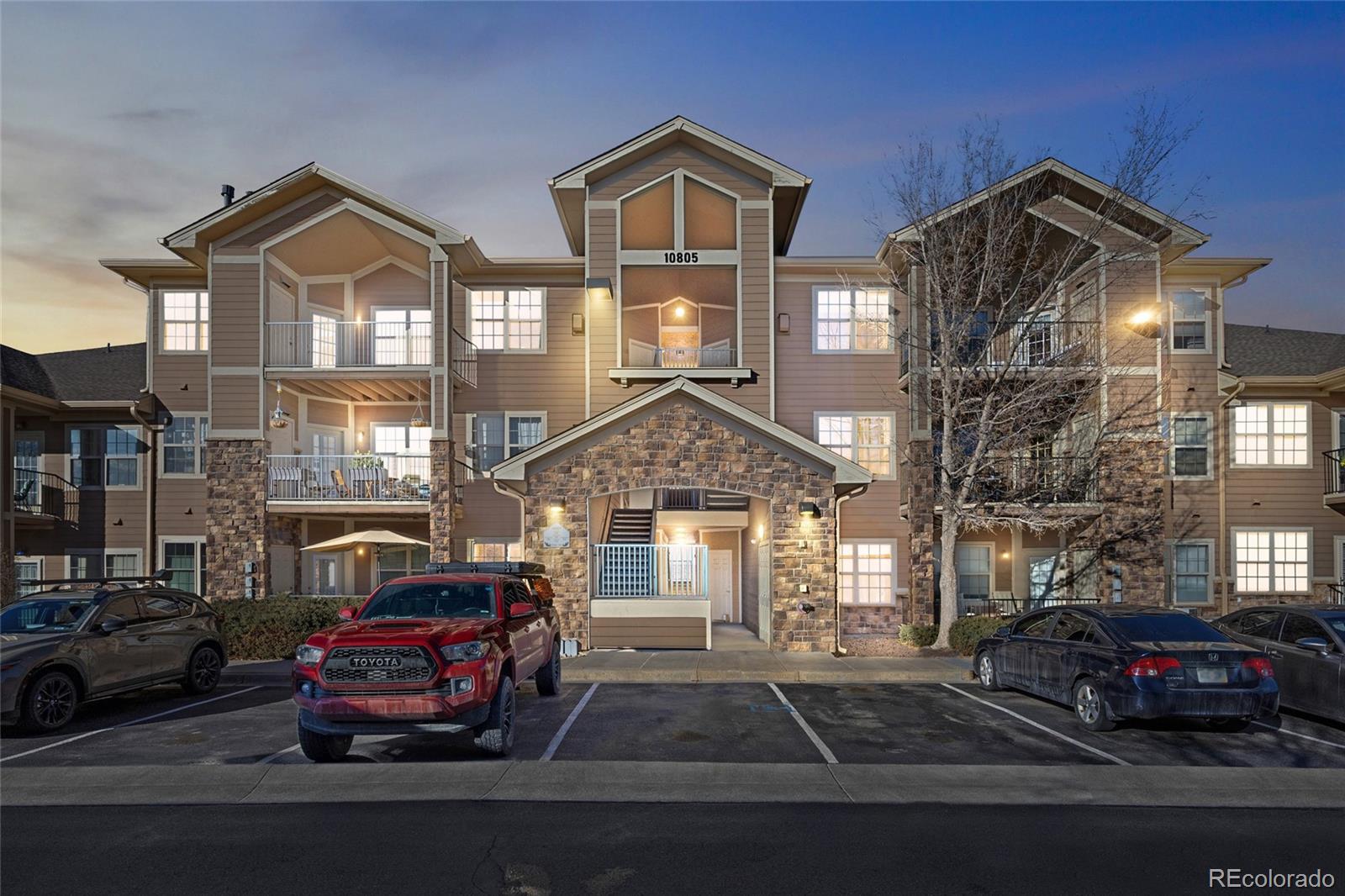 10805 Twenty Mile Road, Unit 104 Parker, CO 80134 - Photo 29 of 43 a car parked in front of a house