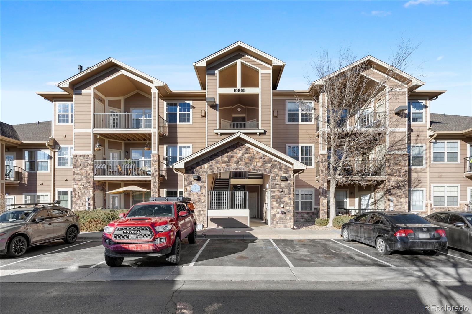 10805 Twenty Mile Road, Unit 104 Parker, CO 80134 - Photo 30 of 43 a car parked in front of a house