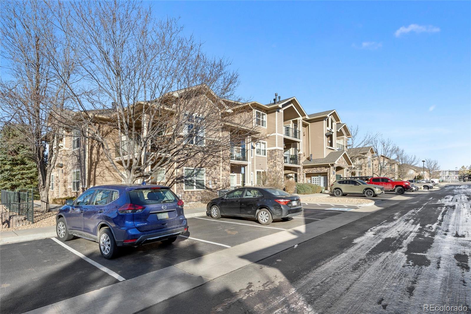 10805 Twenty Mile Road, Unit 104 Parker, CO 80134 - Photo 33 of 43 a car parked in front of a house