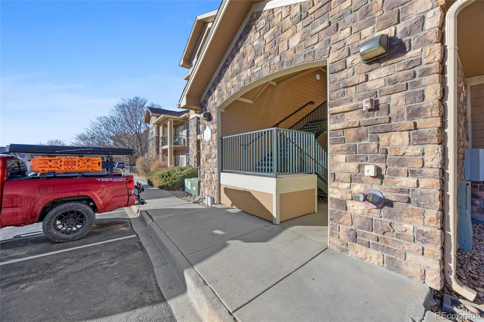 10805 Twenty Mile Road, Unit 104 Parker, CO 80134 - Photo 35 of 43 a view of a car park in front of a building