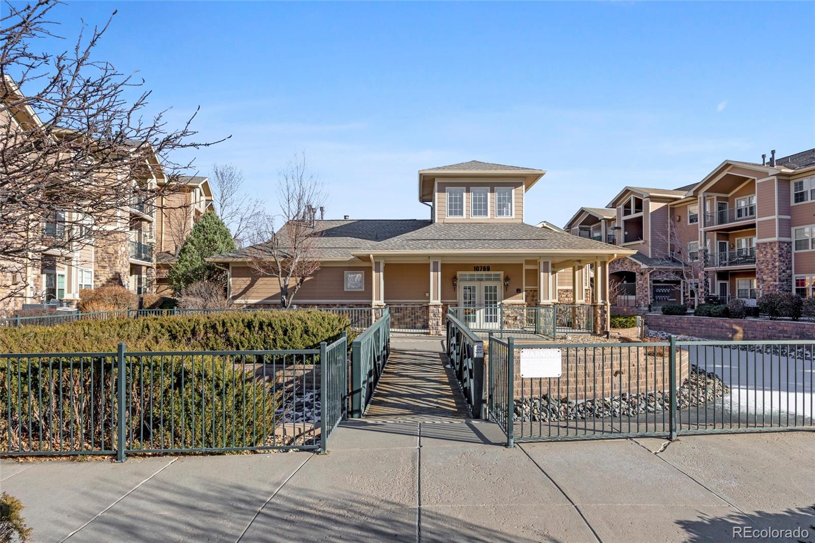 10805 Twenty Mile Road, Unit 104 Parker, CO 80134 - Photo 36 of 43 a front view of a house with a wooden fence
