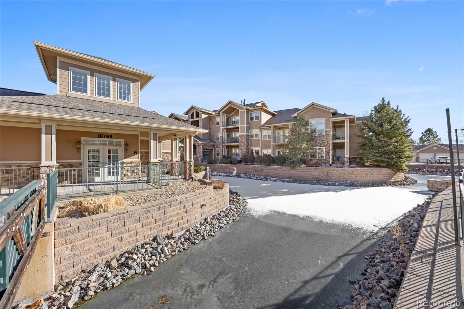 10805 Twenty Mile Road, Unit 104 Parker, CO 80134 - Photo 38 of 43 a front view of a house with a yard