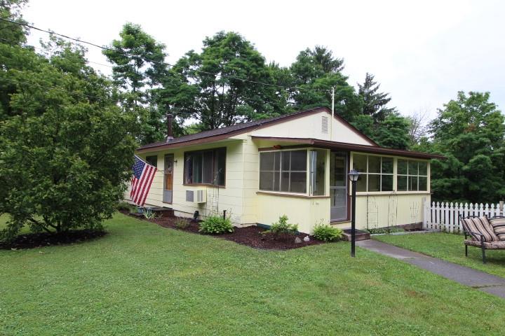 a view of house with backyard