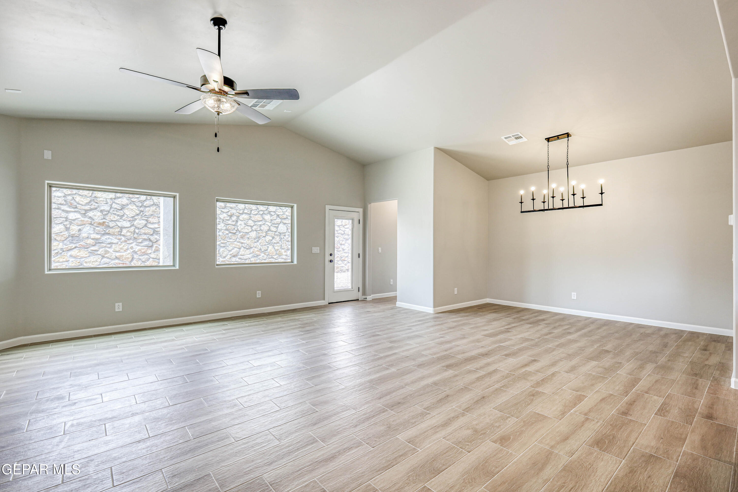 6047 Zinc Hill Street Sunland Park, NM 88008 - Photo 13 of 18 a view of an empty room with wooden floor and a window