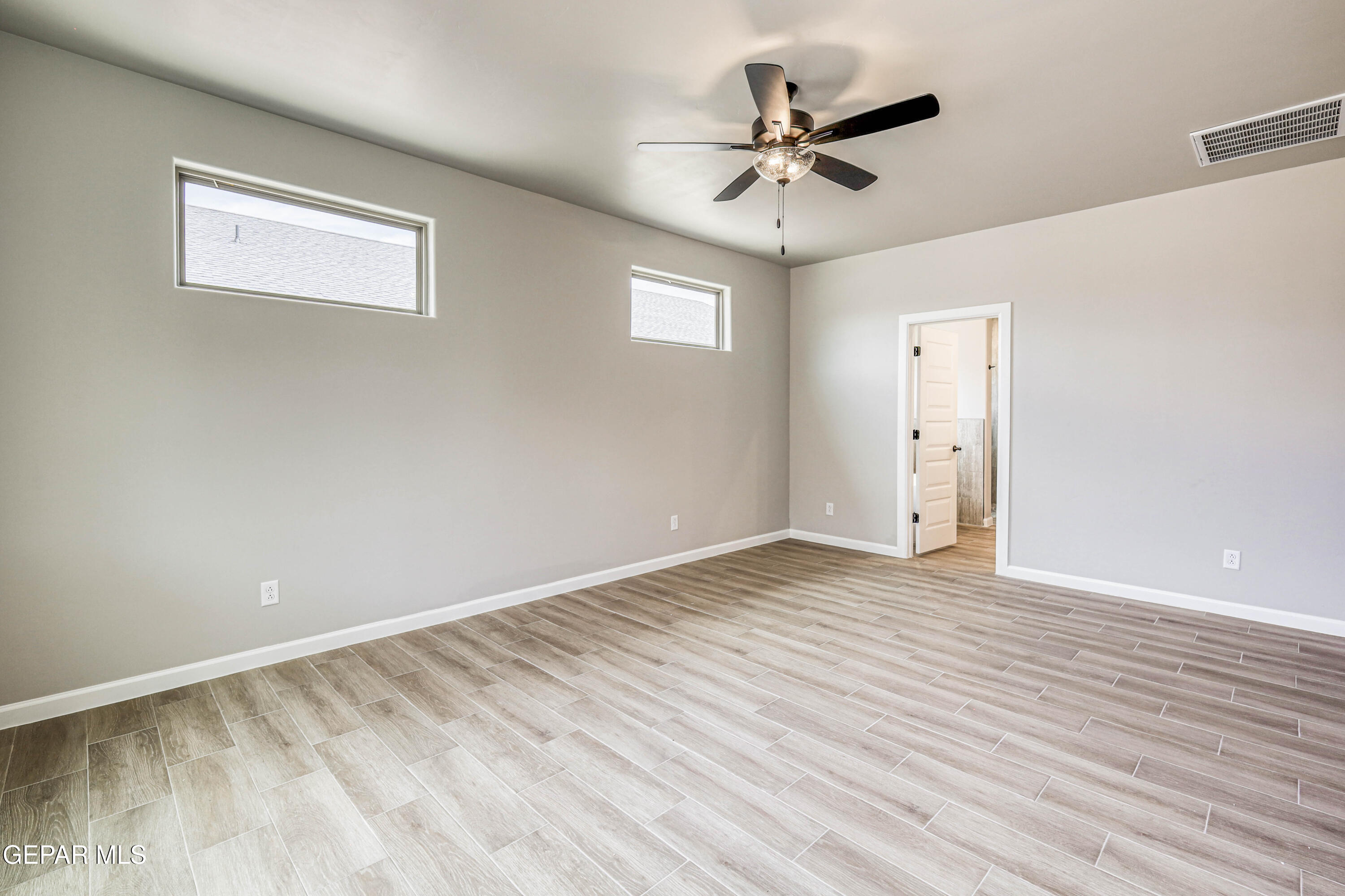 6047 Zinc Hill Street Sunland Park, NM 88008 - Photo 14 of 18 a view of room with wooden floor and ceiling fan