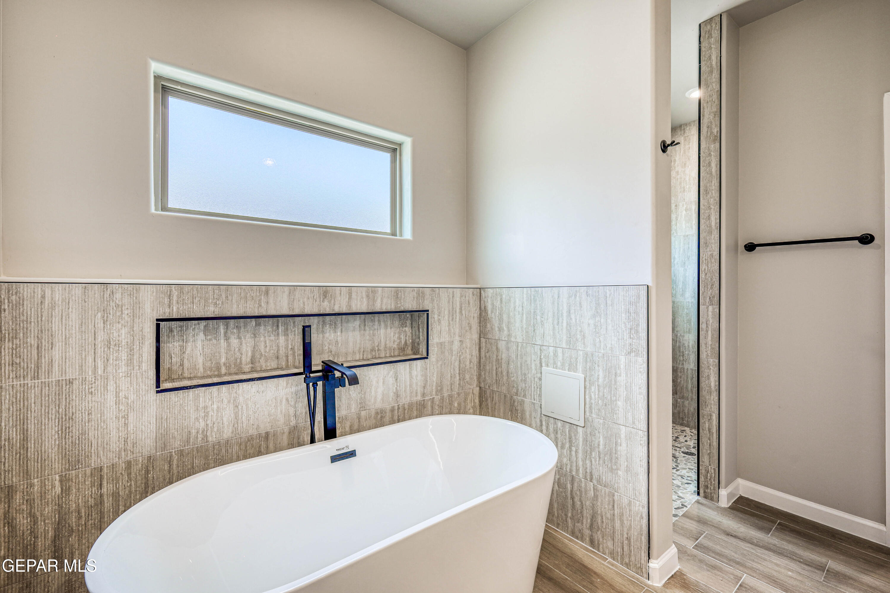 6047 Zinc Hill Street Sunland Park, NM 88008 - Photo 16 of 18 a bathroom with a white tub and shower