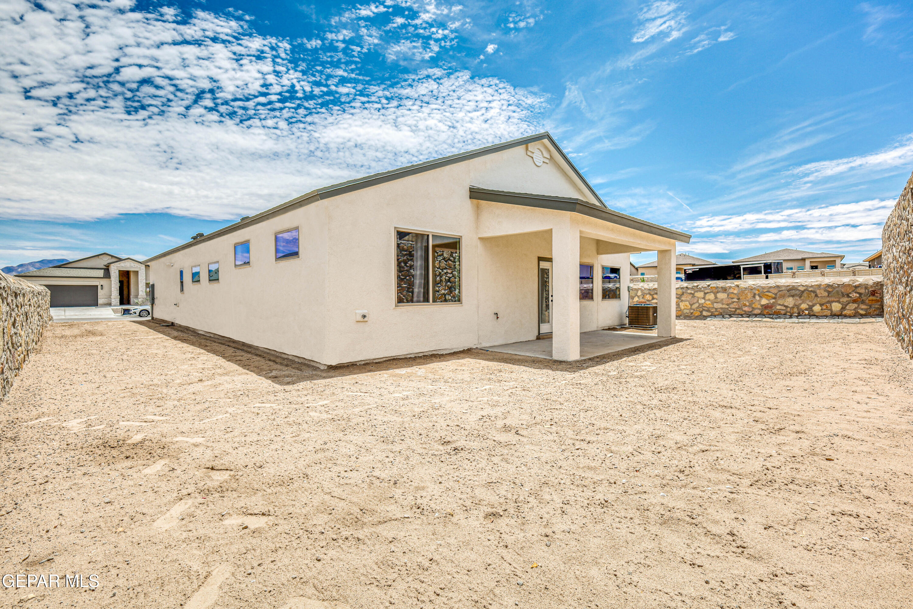 6047 Zinc Hill Street Sunland Park, NM 88008 - Photo 18 of 18 a view of a white house with snow on the road