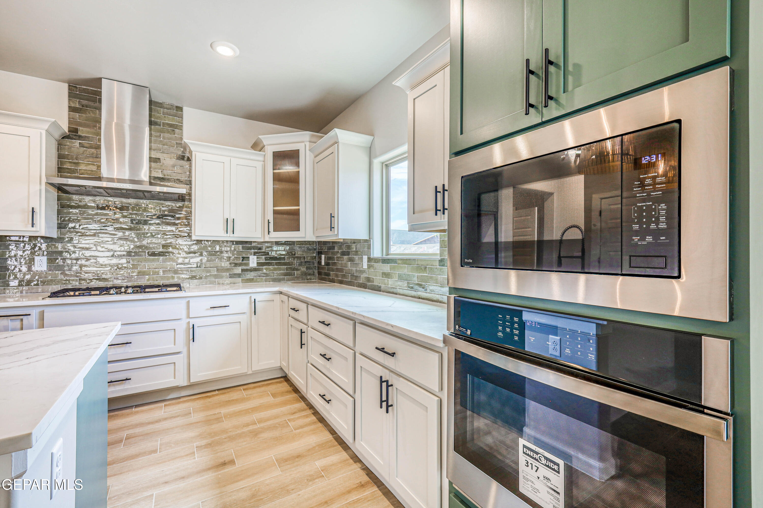 6047 Zinc Hill Street Sunland Park, NM 88008 - Photo 4 of 18 a kitchen with stainless steel appliances granite countertop a stove and cabinets