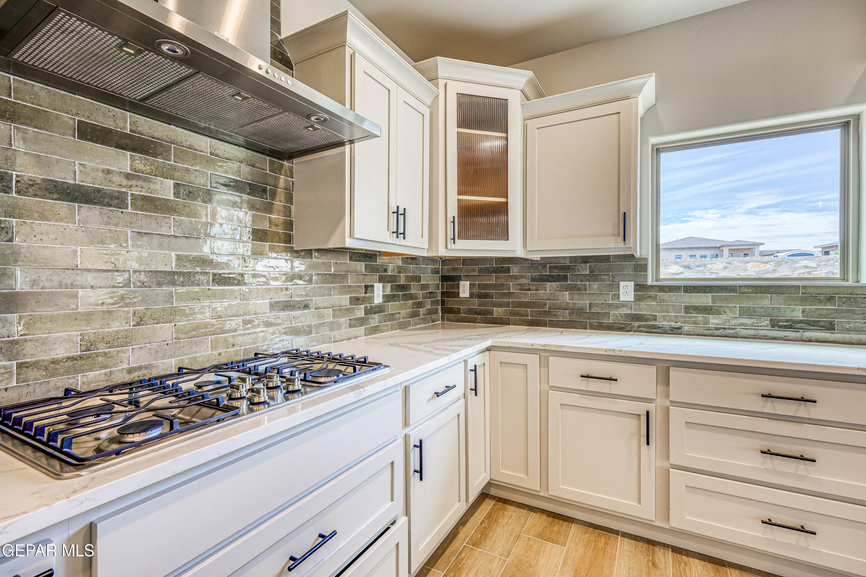 6047 Zinc Hill Street Sunland Park, NM 88008 - Photo 5 of 18 a kitchen with white cabinets and appliances