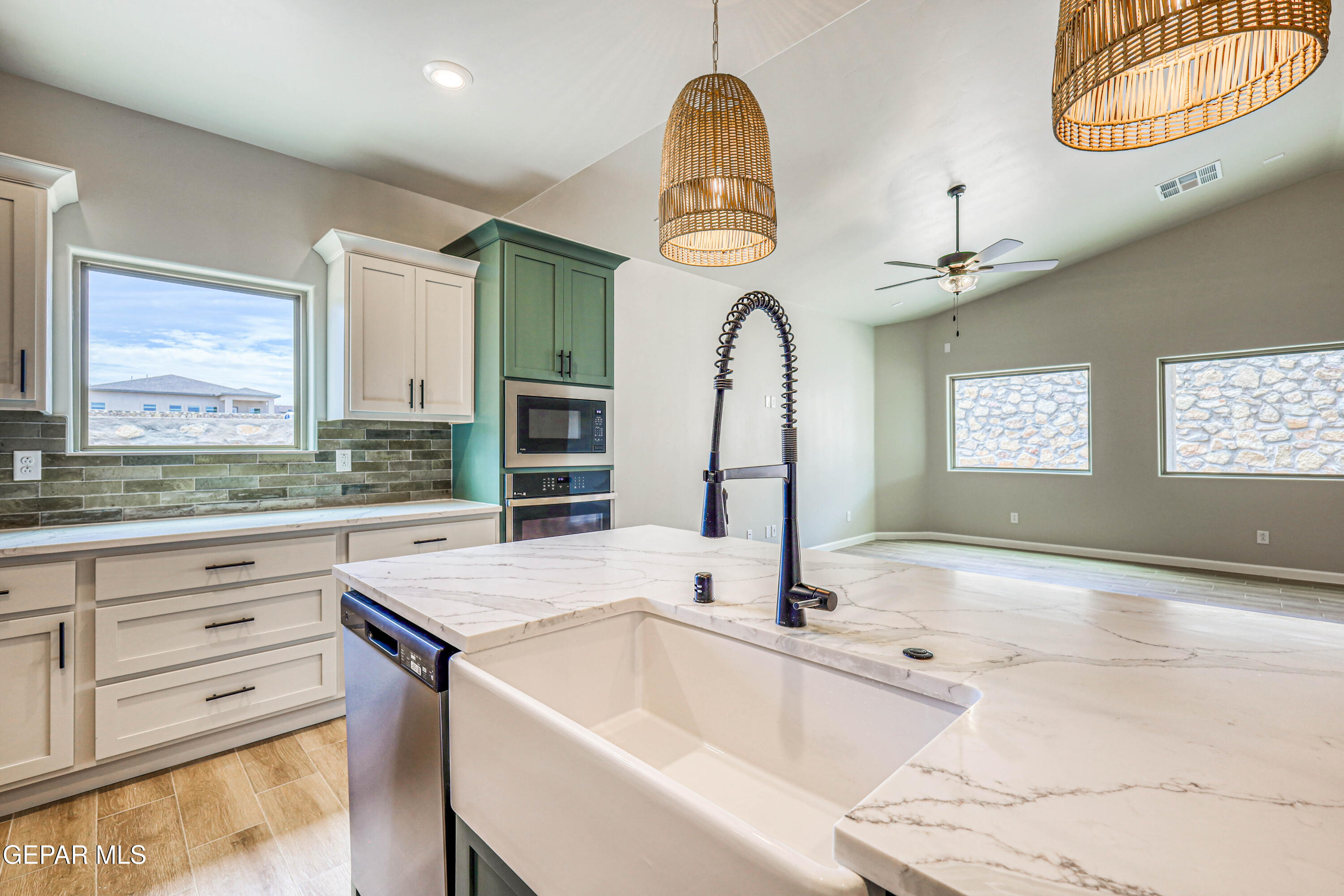 6047 Zinc Hill Street Sunland Park, NM 88008 - Photo 6 of 18 a large kitchen with stainless steel appliances a large counter space a large window and cabinets