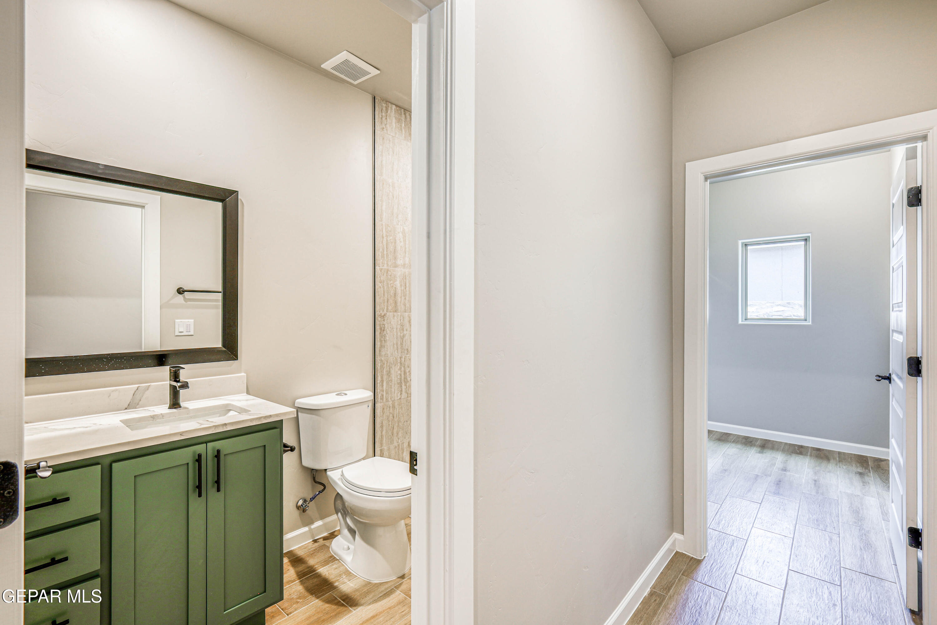 6047 Zinc Hill Street Sunland Park, NM 88008 - Photo 8 of 18 a bathroom with a toilet sink and a mirror