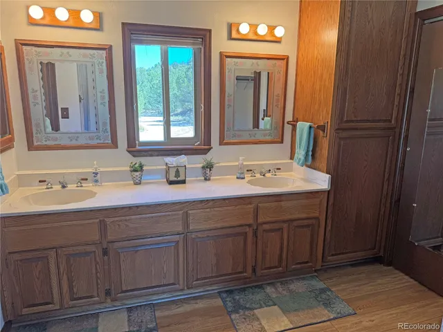 a bathroom with a double vanity sink and a mirror